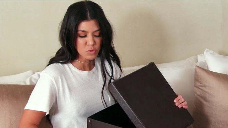 Kourtney Kardashian holding box