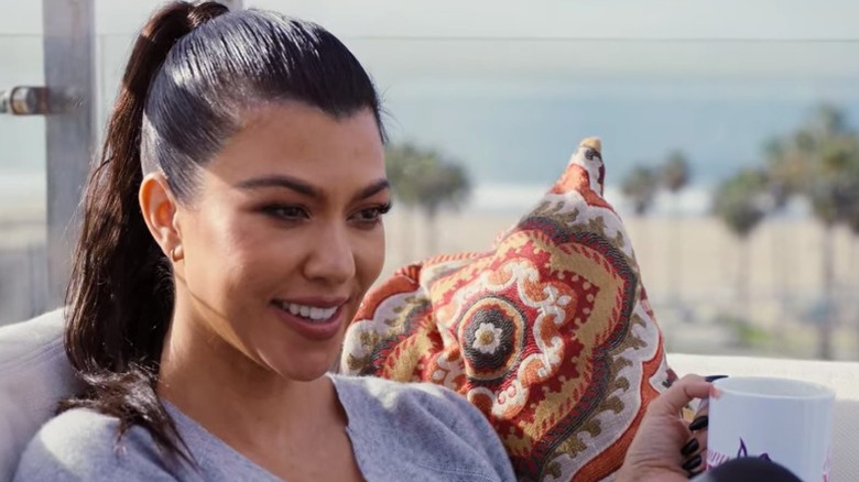 Kourtney Kardashian holding coffee cup