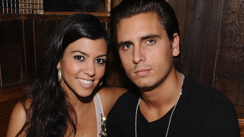 Kourtney Kardashian and Scott Disick posing together at dinner