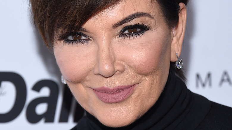 Kris Jenner poses in a black outfit