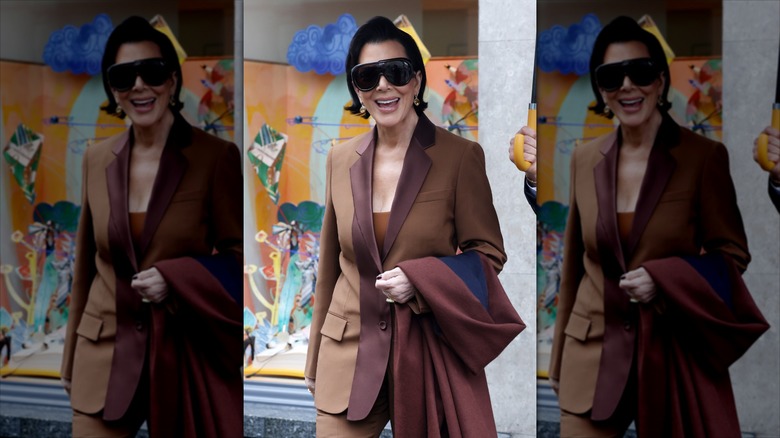 Kris Jenner in a brown suit, smiling