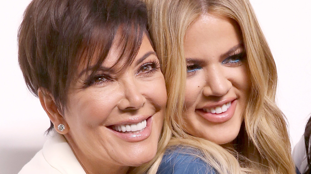 Kris Jenner and Khloe Kardashian embracing on the red carpet 