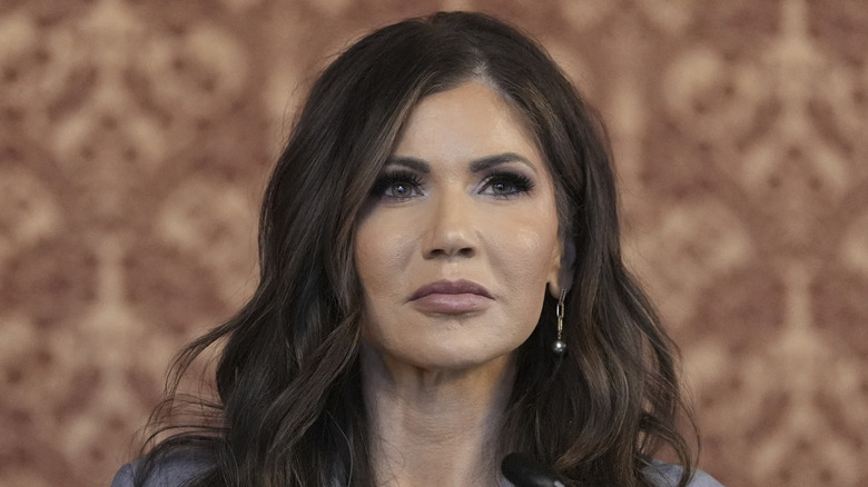 Kristi Noem looks on during press conference