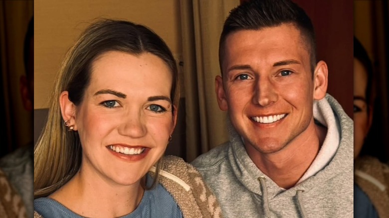 Kassidy Noem Peters and husband smiling while posing with their baby