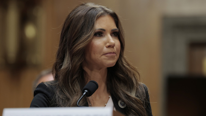 Kristi Noem pressing her lips together during a Senate Committee hearing in May 2025.