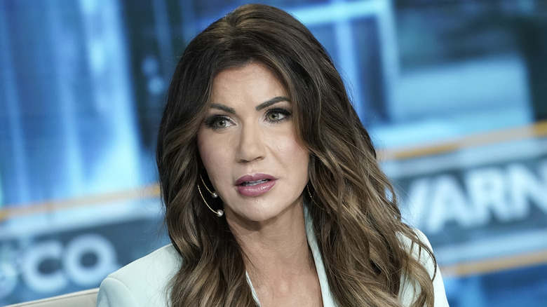 Kristi Noem looks off to the side