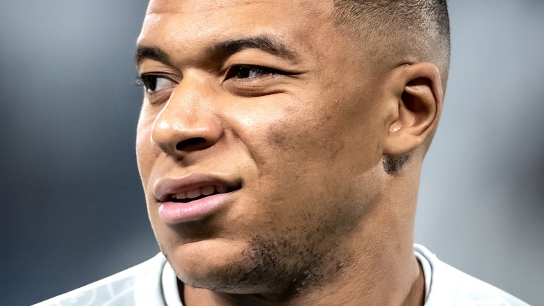 Kylian Mbappé looking away