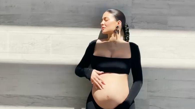 Kylie Jenner posing while pregnant in her announcement video