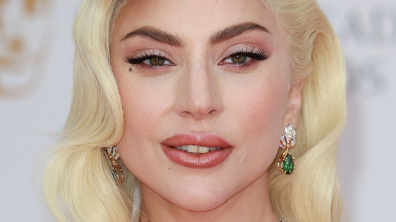 Lady Gaga smiles with platinum blonde hair