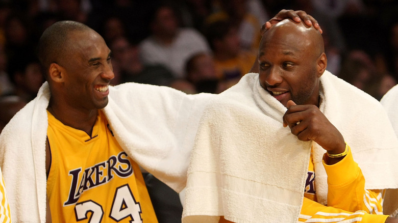 Kobe Bryant #24 and Lamar Odom #7 of the Los Angeles Lakers share a laugh on the bench 2010