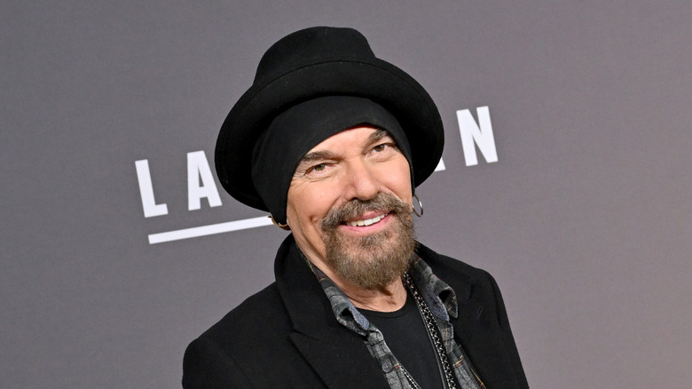 Billy Bob Thornton poses in black headband and hat