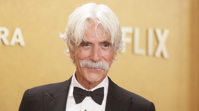 Sam Elliott wearing a black tuxedo and black bow tie