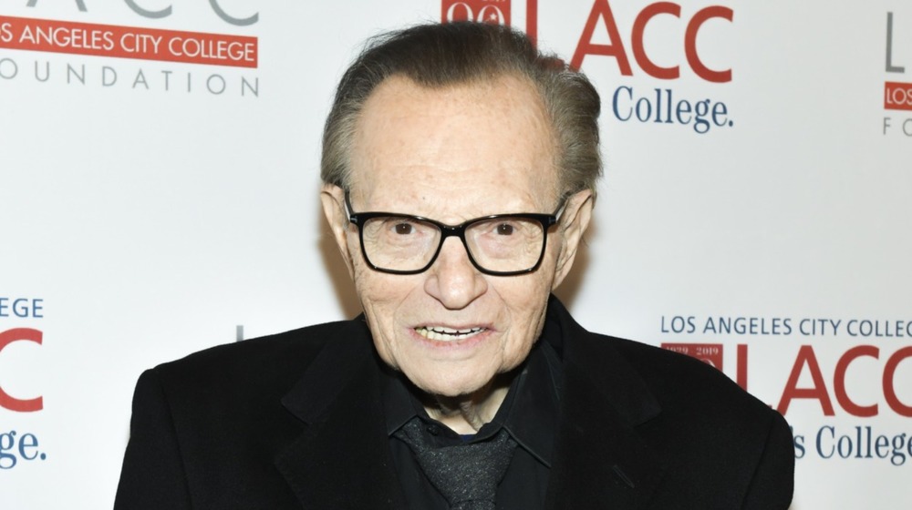 Larry King in all black suit