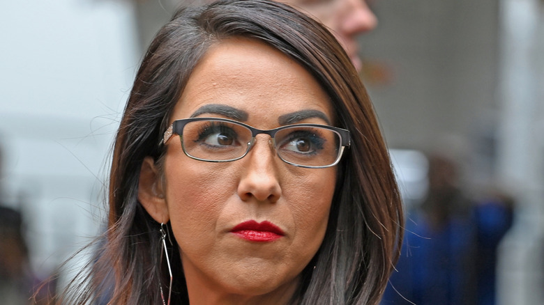 Lauren Boebert staring up with dark eyebrows and red lipstick