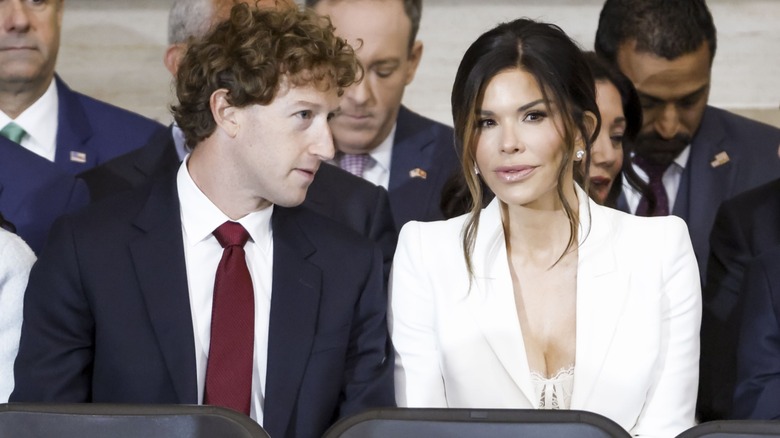 Mark Zuckerberg turns toward an attentive Lauren Sanchez, who's looking at an audience.