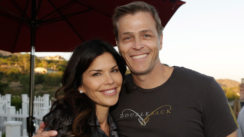 Patrick Whitesell tightly wraps his arms around Lauren Sanchez as they paste wide smiles.