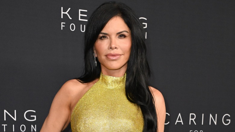 Lauren Sanchez looks directly at the camera while wearing a shimmery olive green dress