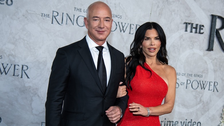 Jeff Bezos and Lauren Sanchez smiling at a red carpet event