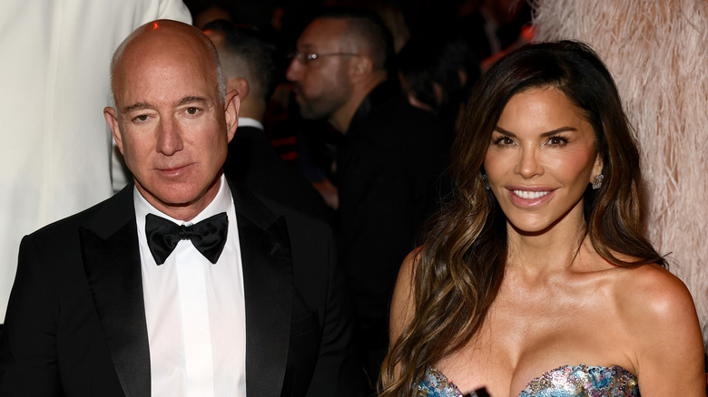 Jeff Bezos frowning next to Lauren Sanchez