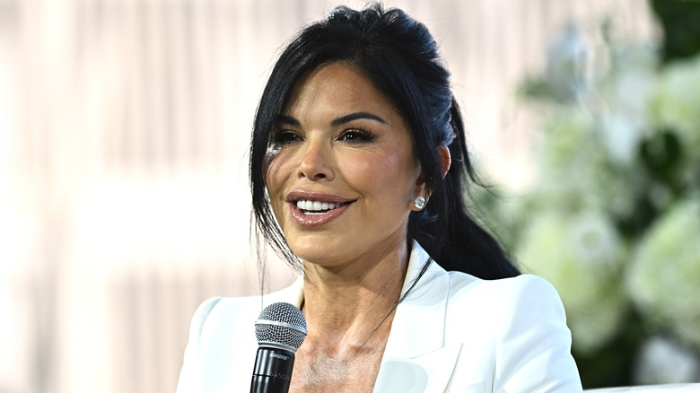 Lauren Sanchez smiling and holding a microphone