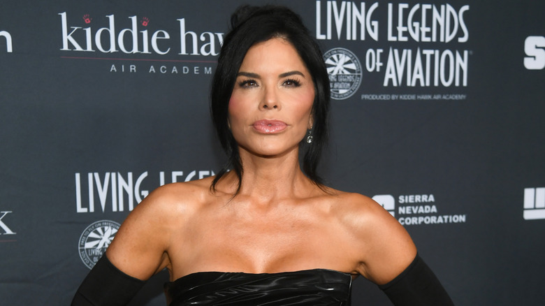 Lauren Sanchez posing in black strapless dress and opera gloves