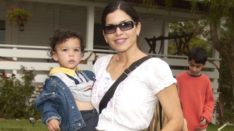 Lauren Sánchez smiling and holding young Nikko Sánchez in her arms.