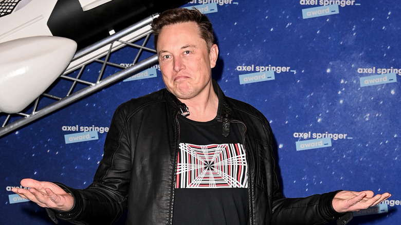 Elon Musk with hands out