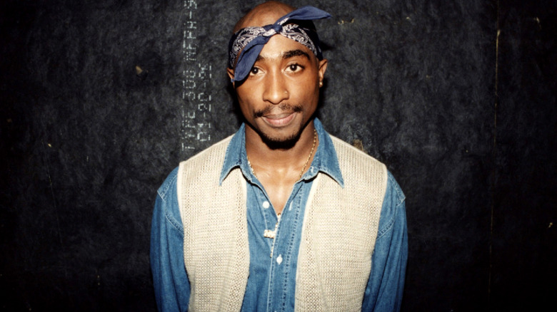 Tupac Shakur posing in denim