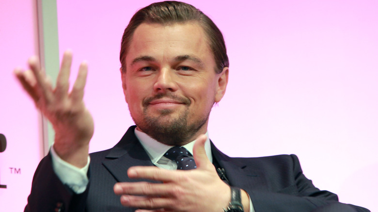 Leonardo Dicaprio holding hands out