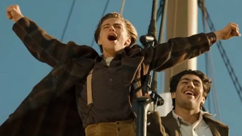 Leonardo DiCaprio outstretching his arms while filming the "king of the world" scene in "Titanic."