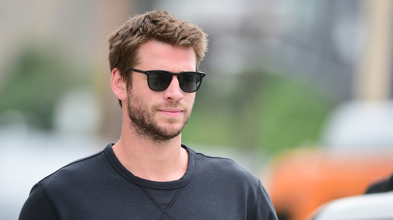 Liam Hemsworth walking around in Los Angeles