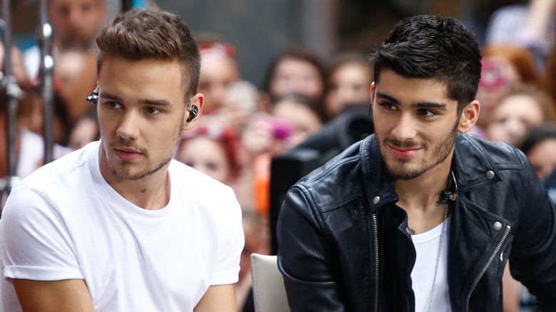 Liam Payne and Zayn Malik sitting next to each other