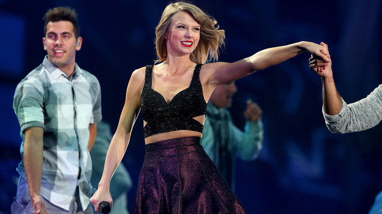 Taylor Swift smiling and performing
