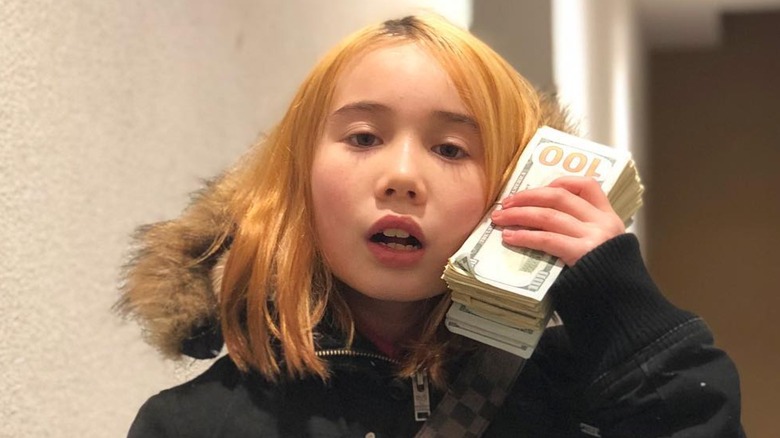 Lil Tay holding $100 bills