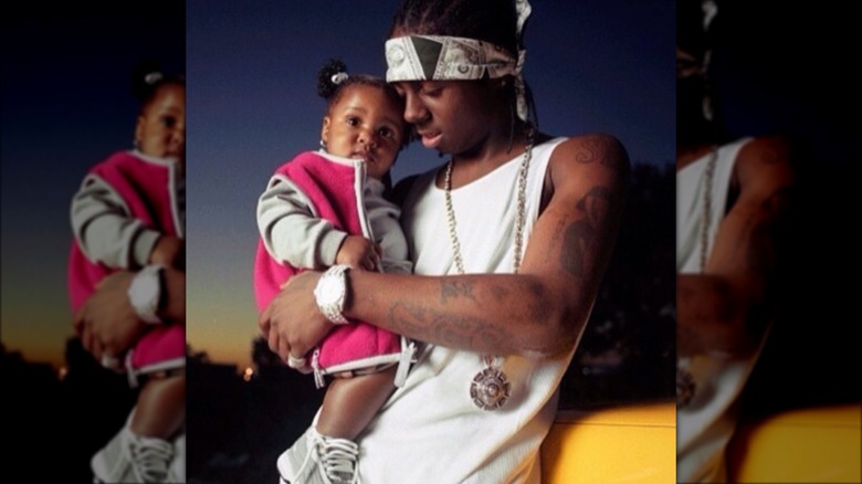 Lil Wayne holding baby daughter Reginae Carter