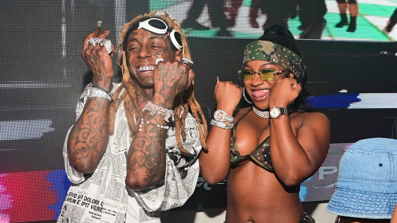 Lil Wayne and Reginae Carter holding up fists