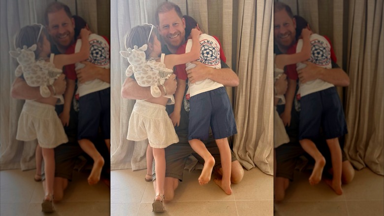 Prince Harry hugging his two children, Lilibet and Archie