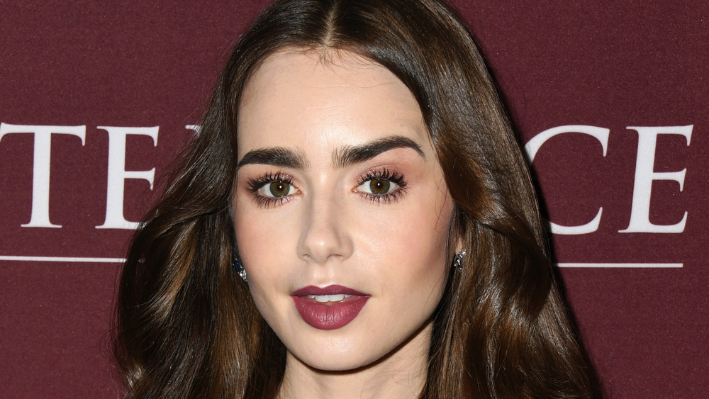 Lily Collins with a slightly surprised expression