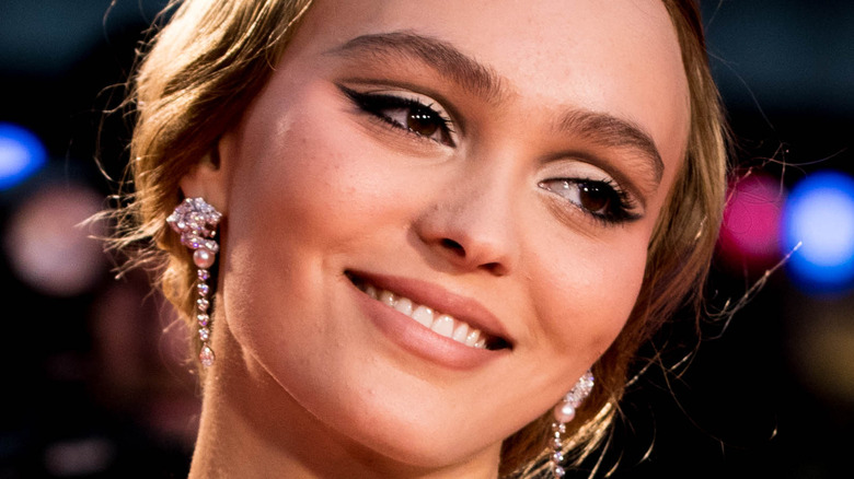 Lily-Rose Depp smiles on a red carpet