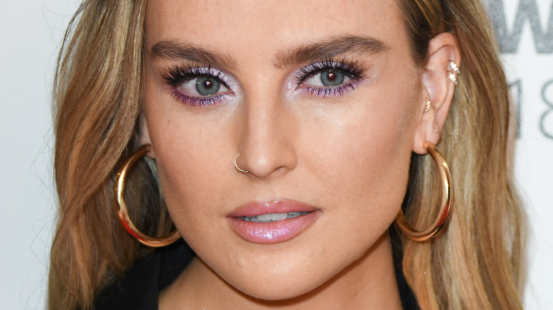 Perrie Edwards looking off to the side