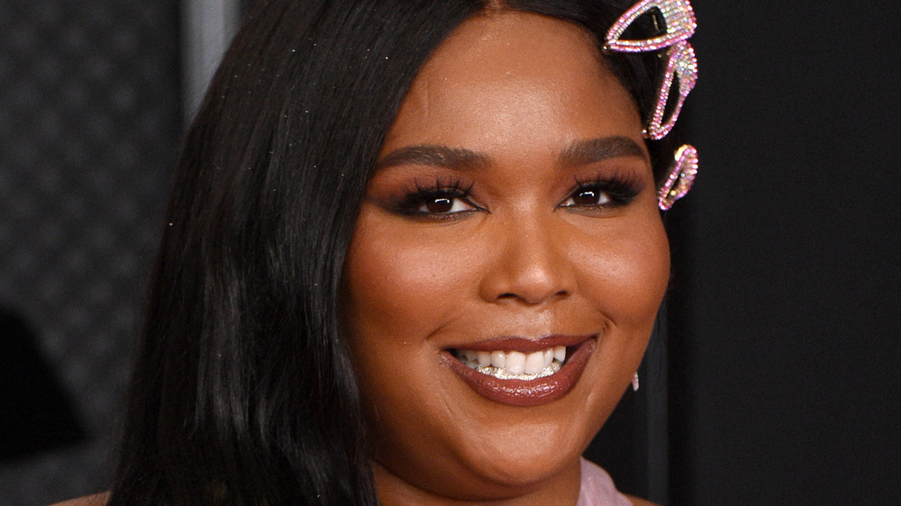 Lizzo smiling on the Grammy Awards red carpet