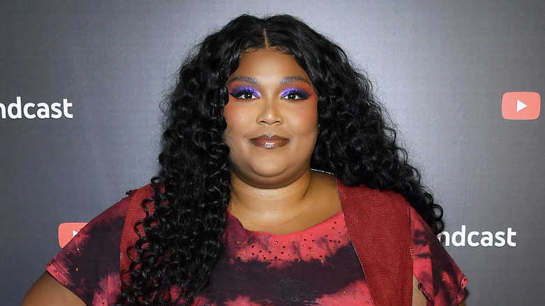 Lizzo in purple eye shadow, smiling