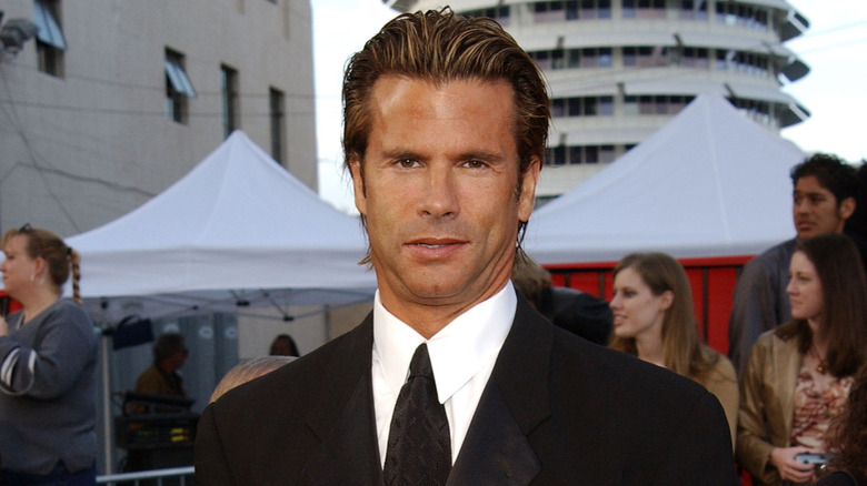 Lorenzo Lamas posing at an event in 2003 in a dark suit