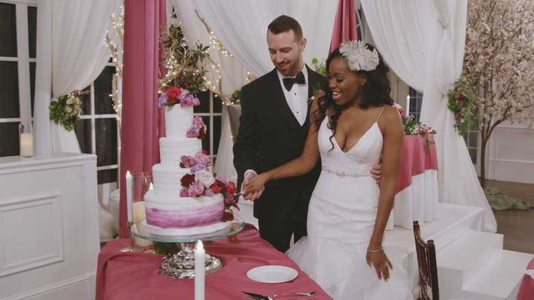Cameron and Lauren cutting their wedding cake