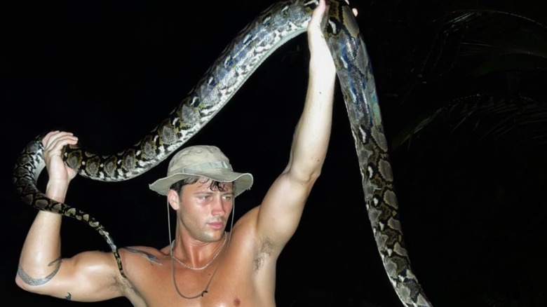 Rob Rousch handling a large snake