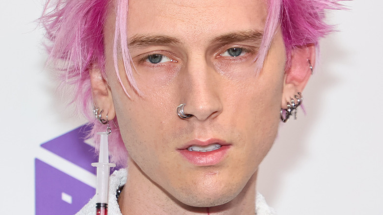 Machine Gun Kelly with beads on face