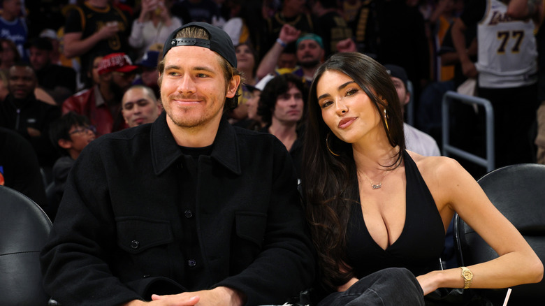 Madison Beer and Justin Herbert courtside at a basketball game
