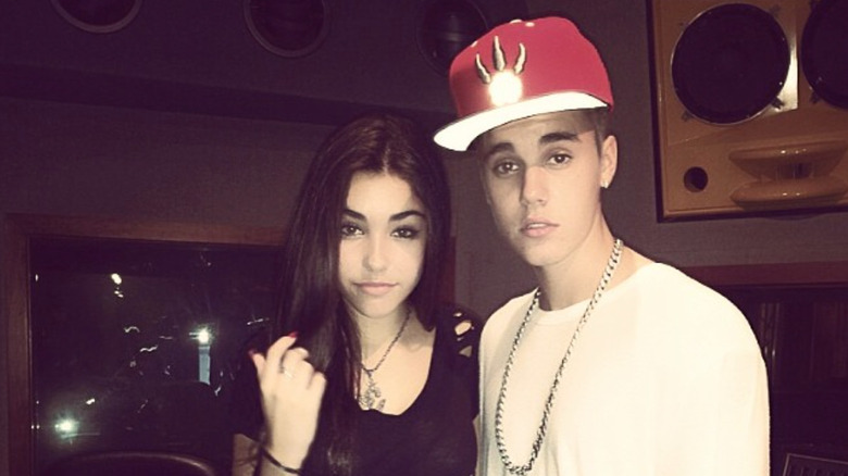 A young Madison Beer poses with Justin Bieber in a recording studio