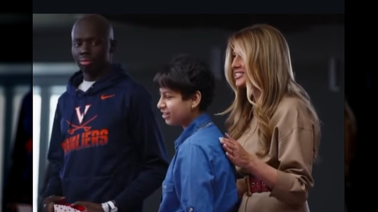 Melania Trump standing among a crowd