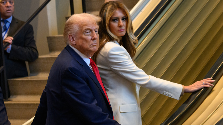 Donald and Melania Trump on an escalator.